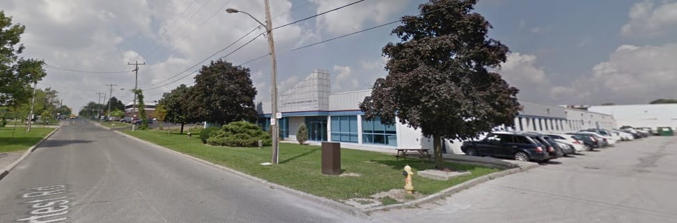 Corner view of the building from Supertest Road with parking